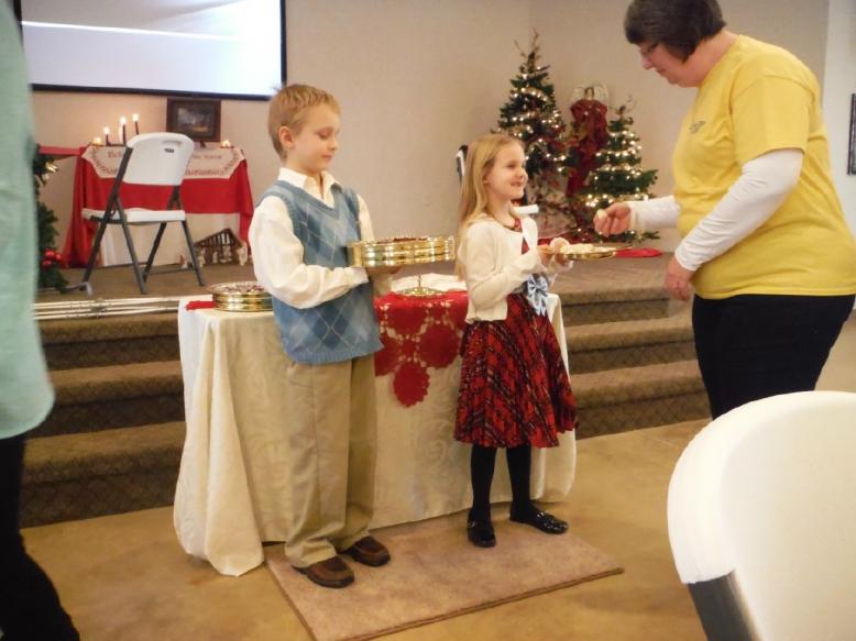 Lucas & Rowan serve communion.